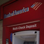 A man walks up to an ATM outside a Bank of America branch in Los Angeles. Bank of America has said it will charge customers a $5 monthly fee to use its debit card — a plan that has set off grumbling from consumer advocates at the highest levels.