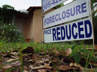 A foreclosure/price reduced sign stands in front of a home for sale on February 11, 2011 in Miami. A foreclosure/price reduced sign stands in front of a home for sale on February 11, 2011 in Miami.