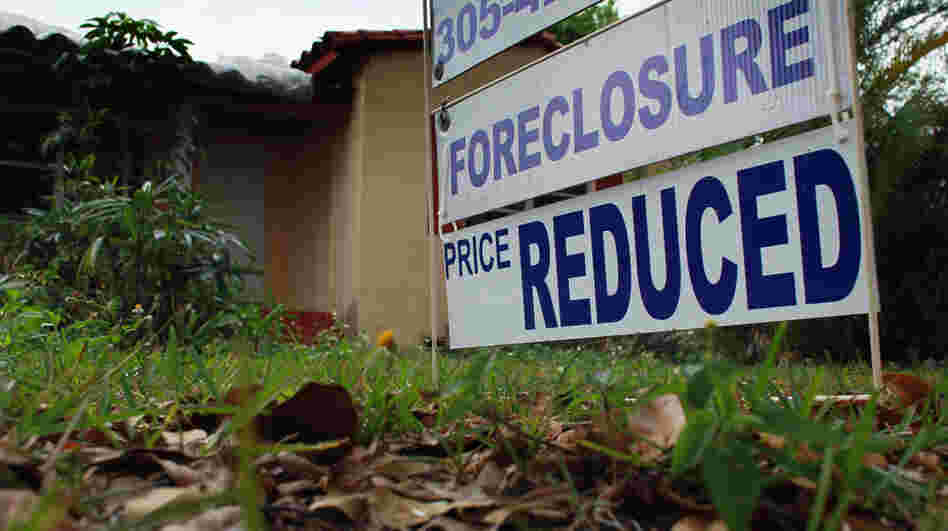 A foreclosure/price reduced sign stands in front of a home for sale on February 11, 2011 in Miami. A foreclosure/price reduced sign stands in front of a home for sale on February 11, 2011 in Miami.