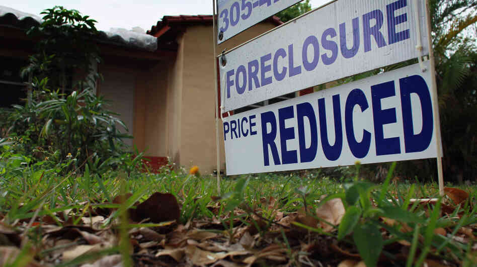 A foreclosure/price reduced sign stands in front of a home for sale on February 11, 2011 in Miami. A foreclosure/price reduced sign stands in front of a home for sale on February 11, 2011 in Miami.