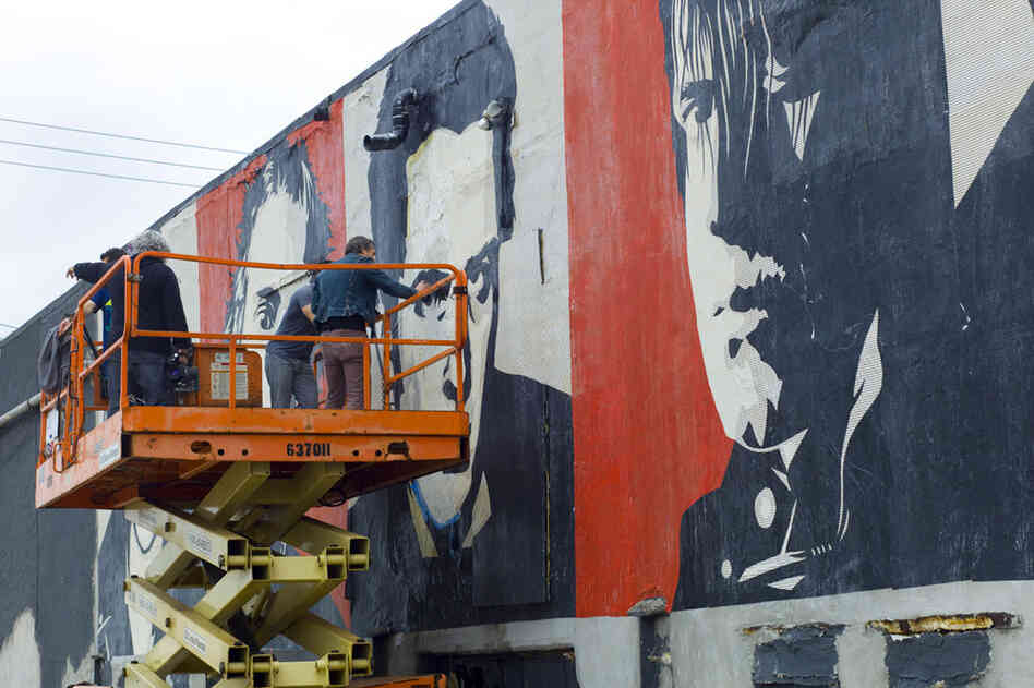 Touching up the rock-star mural outside Asbury Lanes. 