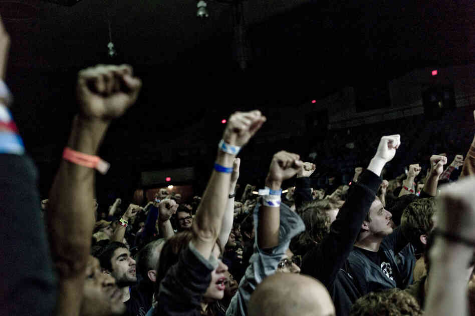 Fans raise their fists with Public Enemy. 