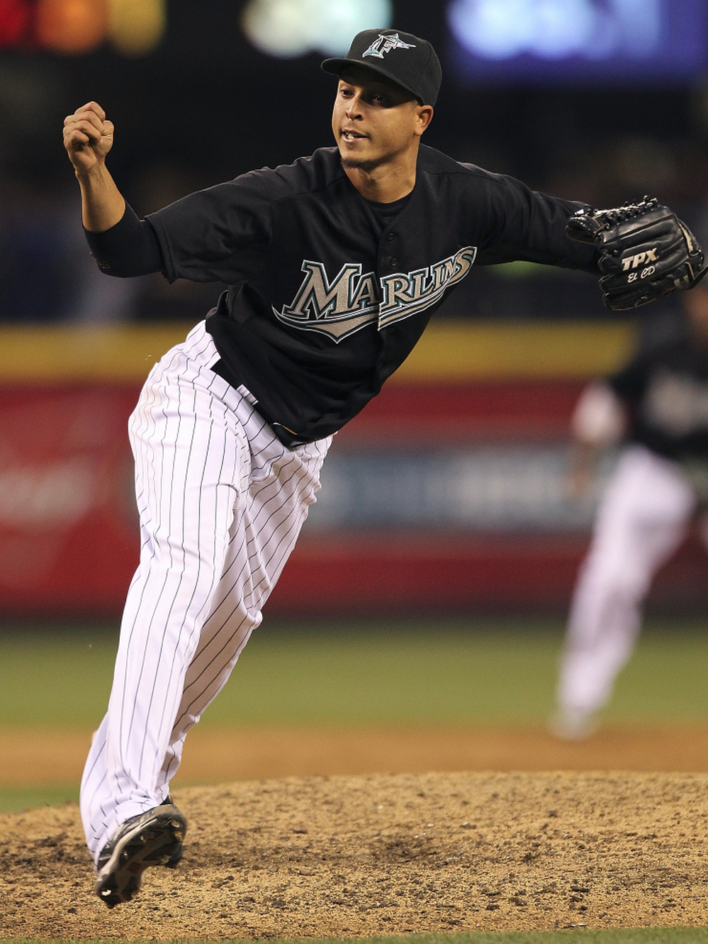 Juan Carlos Oviedo, seen here closing a game for the Marlins under the name Leo Nunez, remains in the Dominican Republic after admitting falsifying documents.