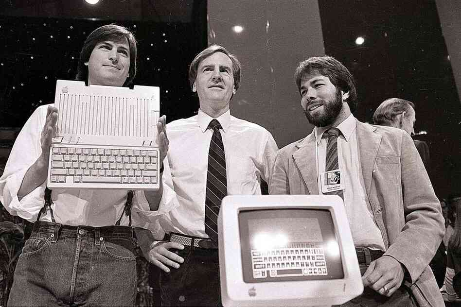 Jobs (left) with John Sculley (center) and Steve Wozniak, co-founder of Apple, unveil the new Apple IIc computer in San Francisco, 1984. 