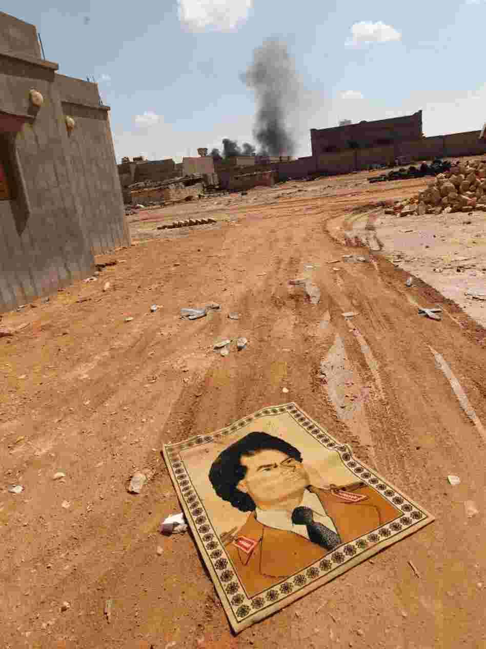 A small carpet with the portrait of Gadhafi lies on the ground near fighting at the front line of Bani Walid, southeast of Tripoli, earlier this month. A small carpet with the portrait of Gadhafi lies on the ground near fighting at the front line of Bani Walid, southeast of Tripoli, earlier this month.