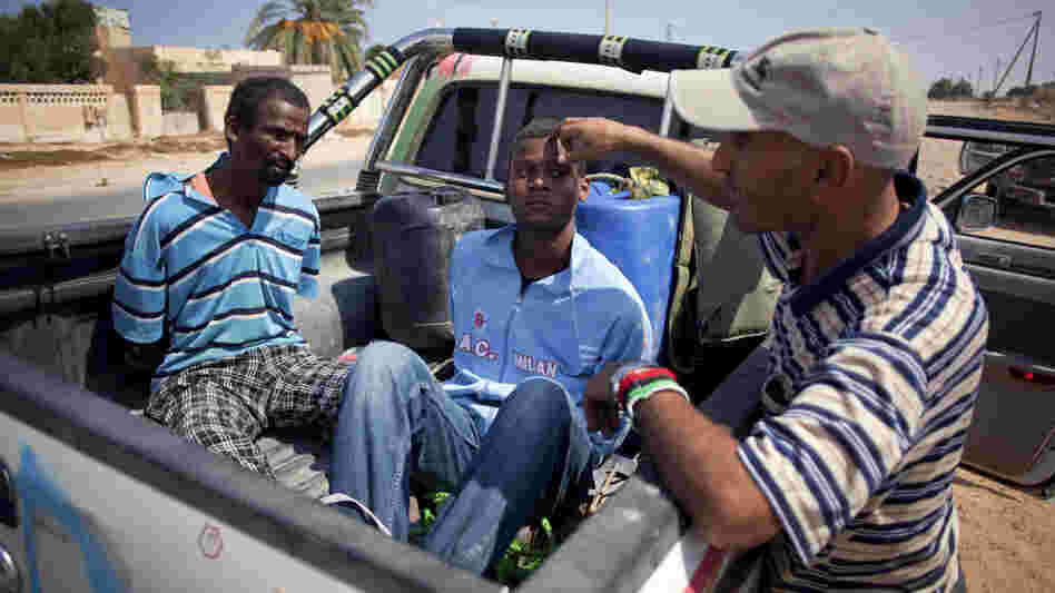A revolutionary fighter watches over two suspected Gadhafi loyalists in Sirte, Libya, last month. By some estimates, up to 30 to 40 percent of Libyans are sympathetic to former dictator Moammar Gadhafi. A revolutionary fighter watches over two suspected Gadhafi loyalists in Sirte, Libya, last month. By some estimates, up to 30 to 40 percent of Libyans are sympathetic to former dictator Moammar Gadhafi.