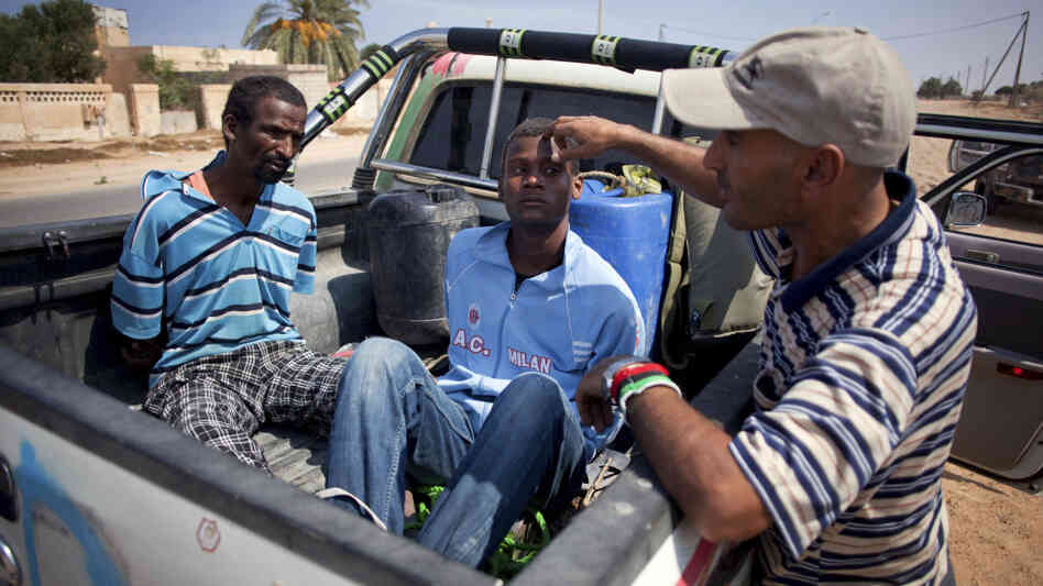 A revolutionary fighter watches over two suspected Gadhafi loyalists in Sirte, Libya, last month. By some estimates, up to 30 to 40 percent of Libyans are sympathetic to former dictator Moammar Gadhafi. A revolutionary fighter watches over two suspected Gadhafi loyalists in Sirte, Libya, last month. By some estimates, up to 30 to 40 percent of Libyans are sympathetic to former dictator Moammar Gadhafi.