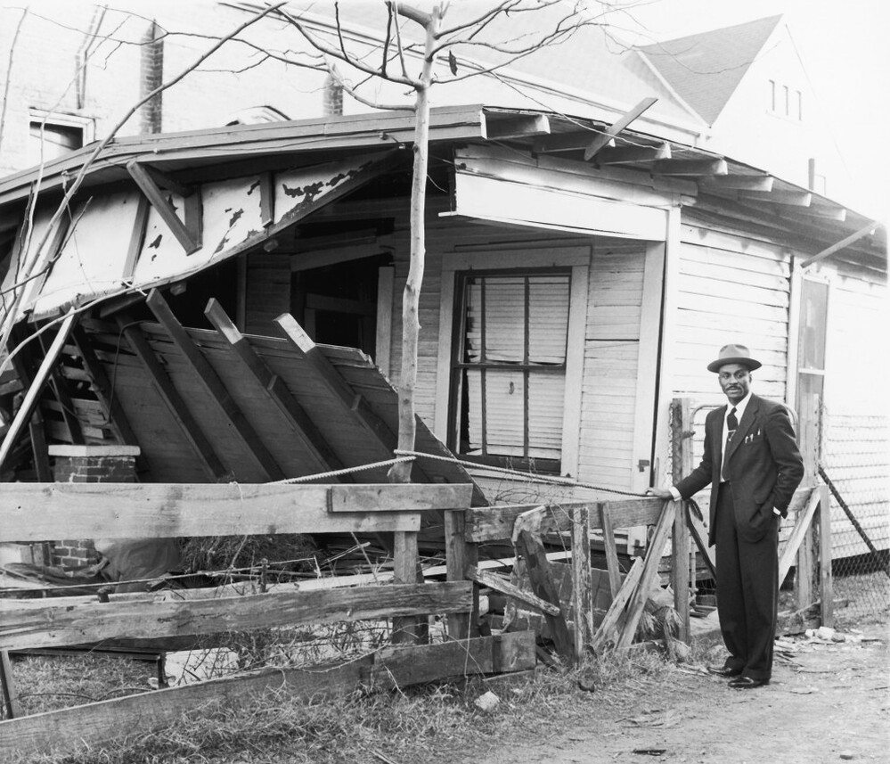 In this undated photo, Shuttlesworth stands near his Birmingham home after it was bombed. 