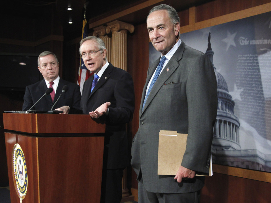 Senate Majority Leader Harry Reid unveils his surtax proposal flanked by Sens. Richard Durbin (l) and Charles Schumer, Oct. 5, 2011. 