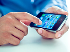 A man taps on his iPhone. A man taps on his iPhone.