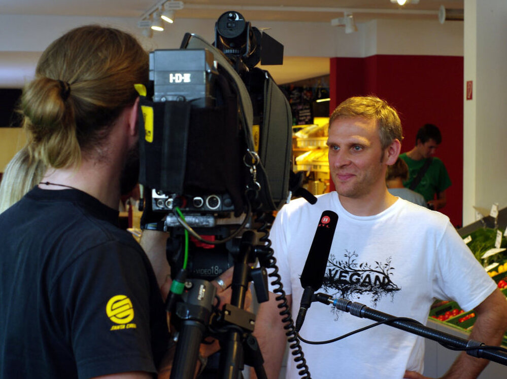 Veganz owner Jan Bredack answers questions for a TV crew. Veganz is Europe's first and only 100% vegan supermarket.