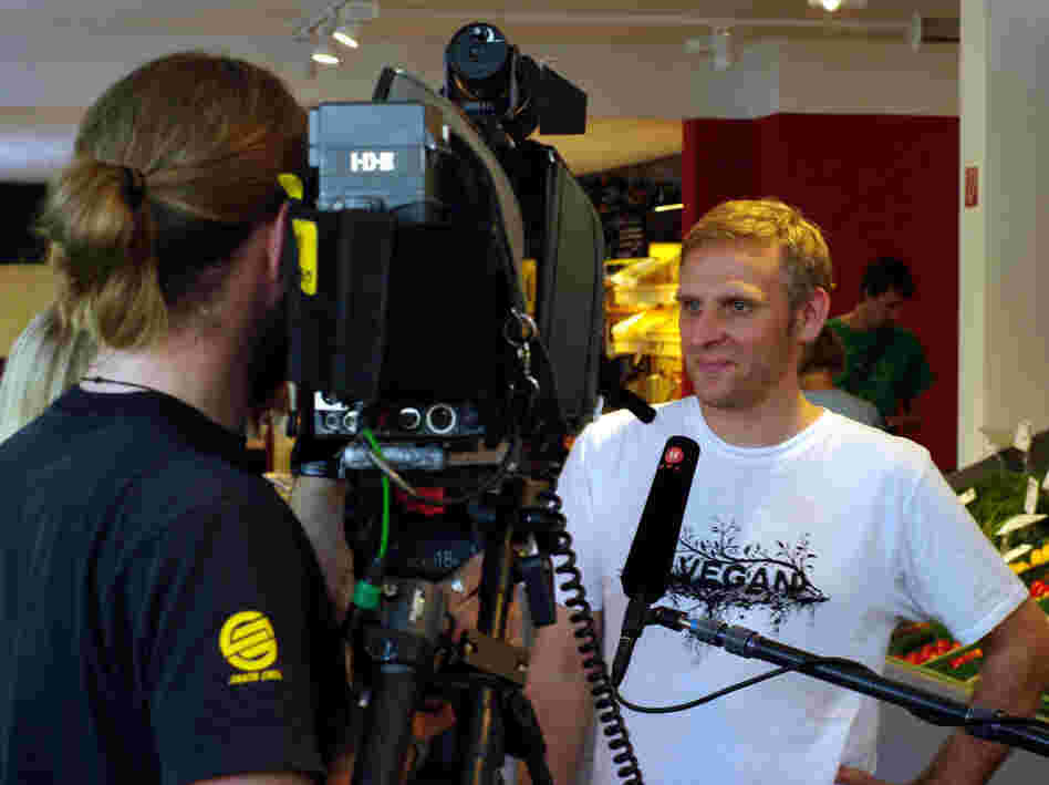 Veganz owner Jan Bredack answers questions for a TV crew. Veganz is Europe's first and only 100% vegan supermarket.