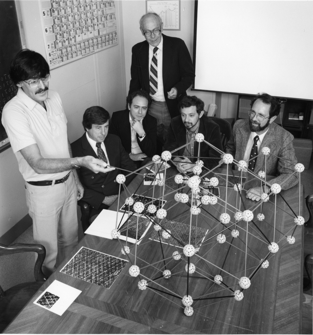 Daniel Shechtman (left) discusses the quasicrystal's structure with collaborators in 1985, just months after shaking the foundations of materials science. Shechtman was awarded the 2011 Nobel Prize for chemistry.
