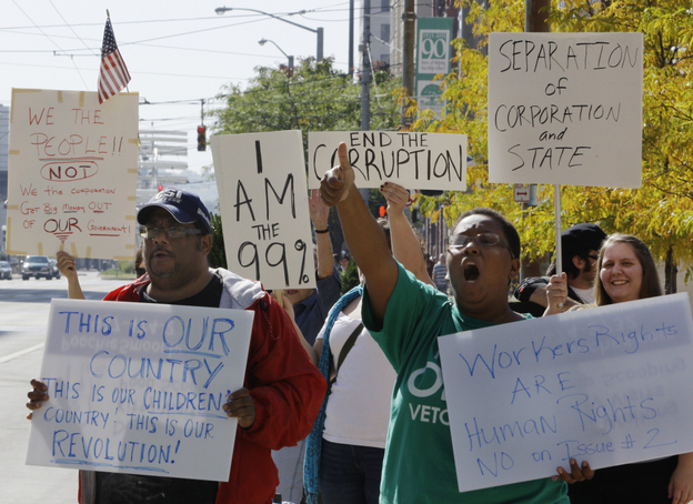 Protesters organized by Occupy Wall Street and Occupy Together yell slogans and hold signs at Courthouse Square in Dayton, Ohio, Wednesday. Several large unions have come out in support of Occupy Wall Street.