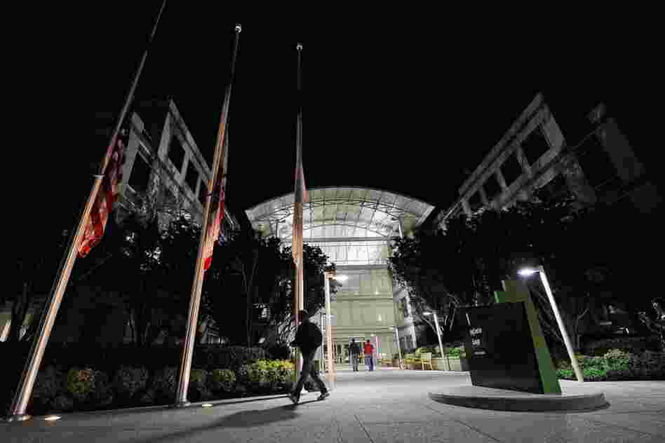 Flags fly at half staff after the death of Steve Jobs at the Apple headquarters in Cupertino, Calif. 