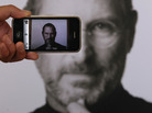 A photographer uses his iPhone to take a picture of a tribute to Apple co-founder Steve Jobs in front of an Apple store in London. Jobs, 56, died Wednesday after a long battle with pancreatic cancer. A photographer uses his iPhone to take a picture of a tribute to Apple co-founder Steve Jobs in front of an Apple store in London. Jobs, 56, died Wednesday after a long battle with pancreatic cancer.