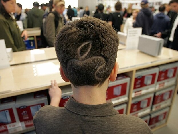 Allen Paltrow-Krulwich sports the apple logo in his hair at the grand opening of the new Apple Store on 5th Avenue in New York May 19, 2006.