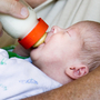 Grandfather feeds a young baby. Grandfather feeds a young baby.