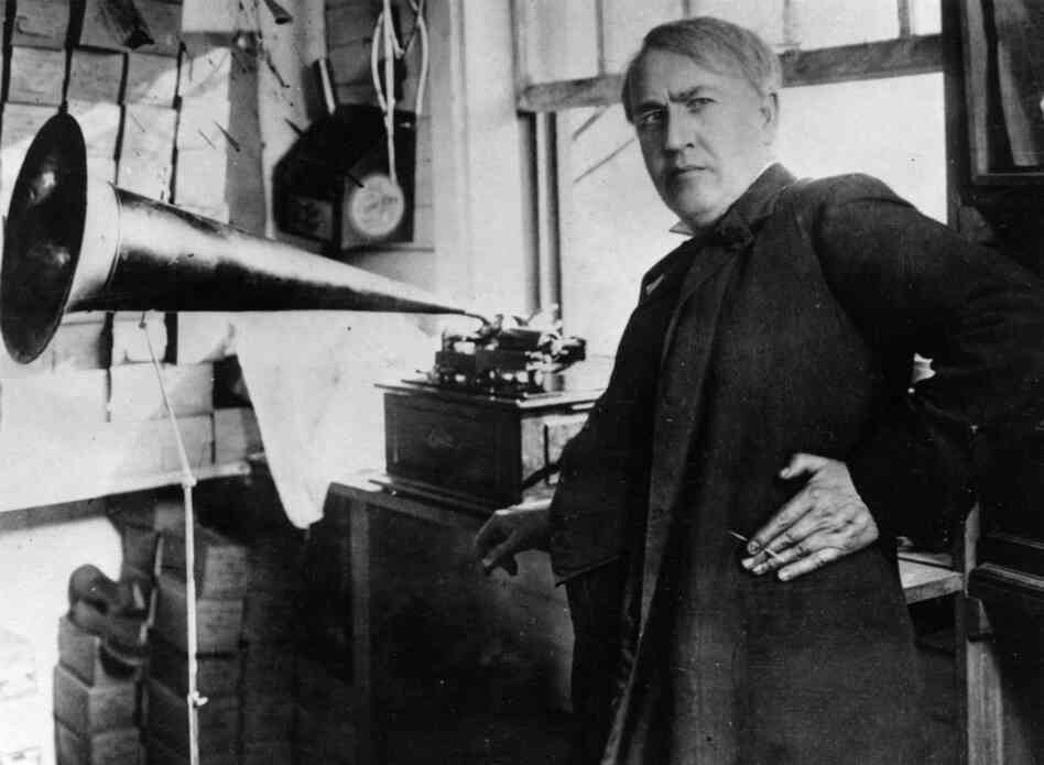Thomas Alva Edison:  Transformed American industry and culture by inventing the phonograph and the motion picture camera and developing a long-lasting electric light bulb. Known as the Wizard of Menlo Park, Edison also founded General Electric. In this photo from 1877, Edison stands with the phonograph. 