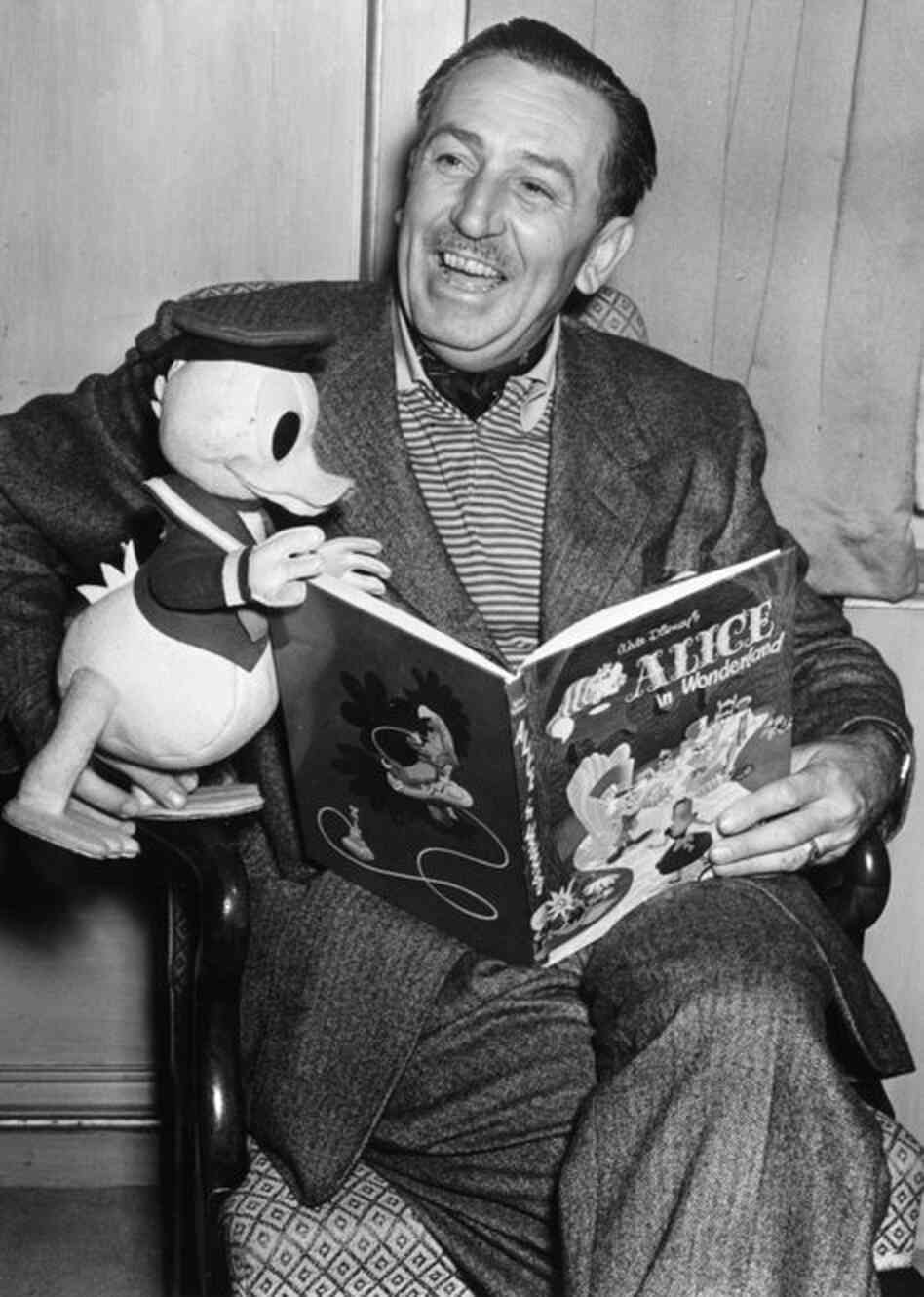 Walt Disney:  Revolutionized animation and inspired iconic characters, stories and Walt Disney Co. theme parks that have become a permanent fixture in popular culture. Disney posed with a Donald Duck character while reading from Alice in Wonderland during a 1951 movie premiere in London. 