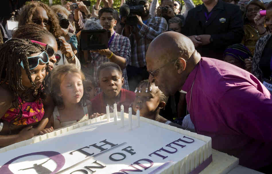 Children help retired Archbishop Desmond Tutu blow out candles on a cake during a celebration of his 80th birthday in Stellenbosch, South Africa, on Friday. Children help retired Archbishop Desmond Tutu blow out candles on a cake during a celebration of his 80th birthday in Stellenbosch, South Africa, on Friday.