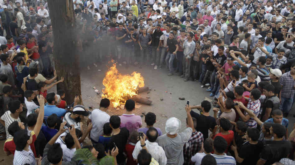 Protesters opposed to Syrian President Bashar Assad burn an effigy of him during Friday prayers in Tripoli, Lebanon. Protesters opposed to Syrian President Bashar Assad burn an effigy of him during Friday prayers in Tripoli, Lebanon.