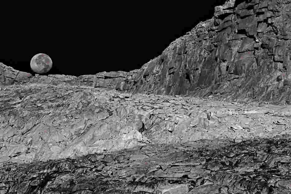 A setting moon makes a fitting backdrop for a lunarlike landscape near Donohue Pass.