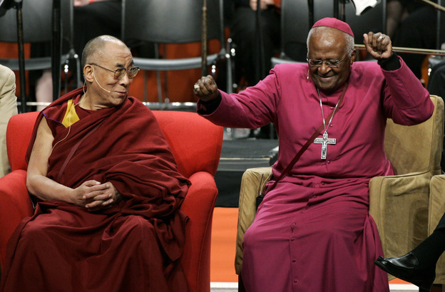 The Dalai Lama looks on as Tutu does a dance after remarking that his wireless microphone made him feel like pop star Michael Jackson, during an event at the University of Washington in Seattle in 2008.