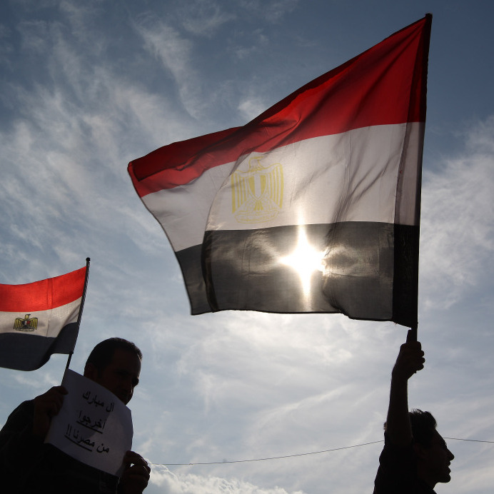 Jan. 30, 2011: Men in Cairo's Tahrir Square hold Egyptian flags.