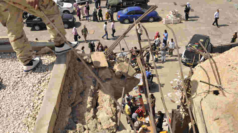 Libyans visit the destroyed Bab al-Azizia military barracks and compound of their country's ousted leader Moammar Gadhafi, in the southern suburbs of Tripoli, Libya.
