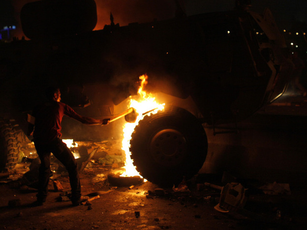 A Coptic Egyptian demonstrator sets on fire an army vehicle during clashes with Egyptian army soldiers following a demonstration in Cairo on Sunday.