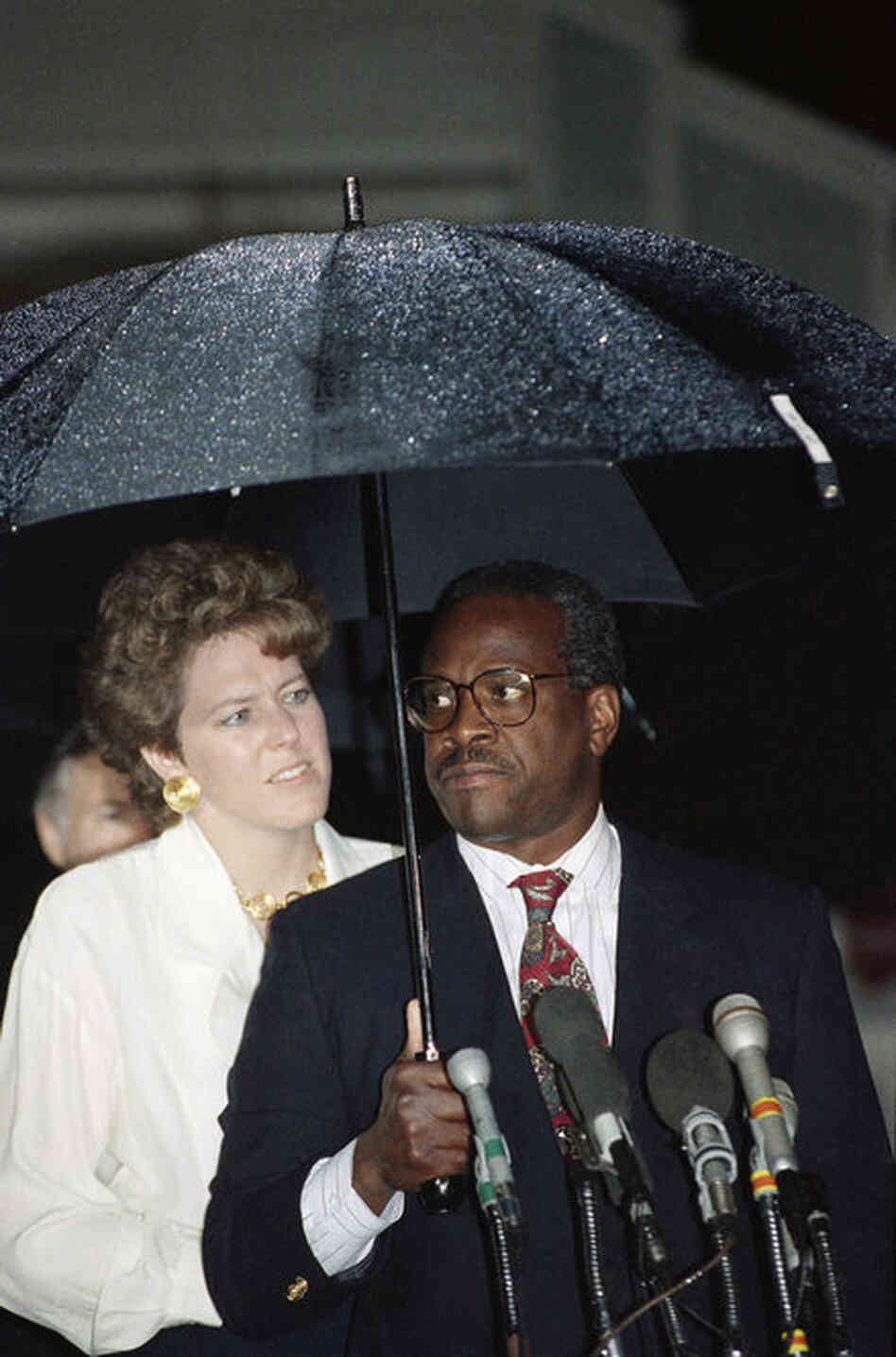 Thomas and his wife, Virginia, talk to reporters in front of his home in Alexandria, Va., on Oct. 15, after the Senate approved his nomination by a vote of 52-48. 