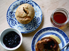 A table set with blackberry popover, blackberry jam and honey for serving A table set with blackberry popover, blackberry jam and honey for serving