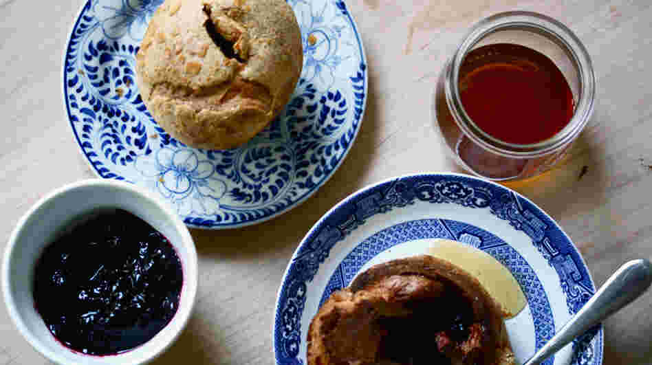 A table set with blackberry popover, blackberry jam and honey for serving 