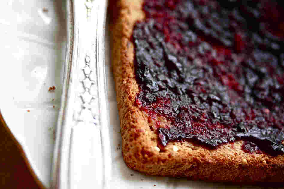 A slice of toast spread with blackberry jam