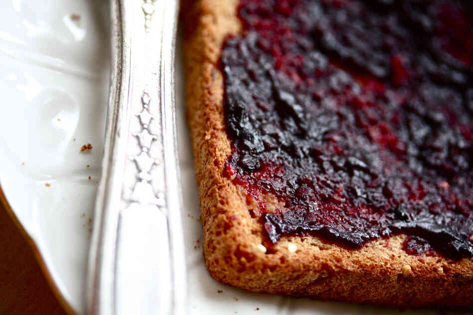 A slice of toast spread with blackberry jam
