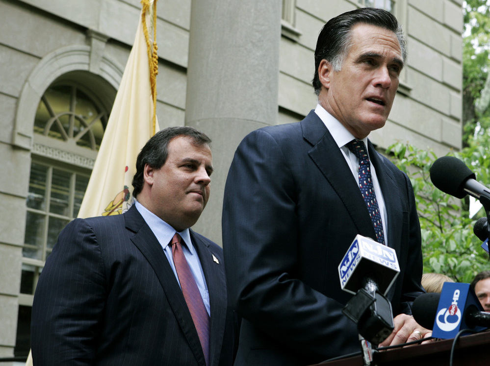 Then-New Jersey gubernatorial candidate Chris Christie listens as Mitt Romney endorses him in the GOP primary, May 28, 2009.