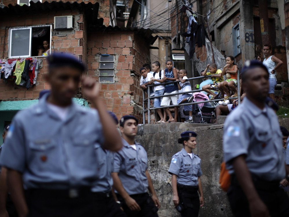 Police officers of the Peacemaker Police Unit program, UPP, patrol the Morro dos Macacos slum last year. The city has stepped up efforts at community policing in order to rid the favelas of drug traffickers.