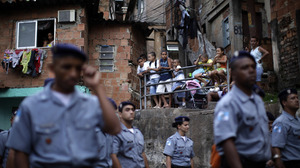 Police officers of the Peacemaker Police Unit program, UPP, patrol the Morro dos Macacos slum last year. The city has stepped up efforts at community policing in order to rid the favelas of drug traffickers.