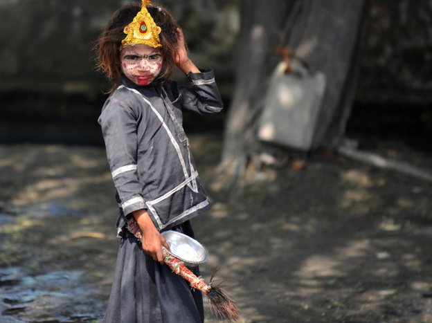 An Indian girl with her face painted begs on the outskirts of New Delhi. Despite India's rapid economic growth, poverty and begging are still common.