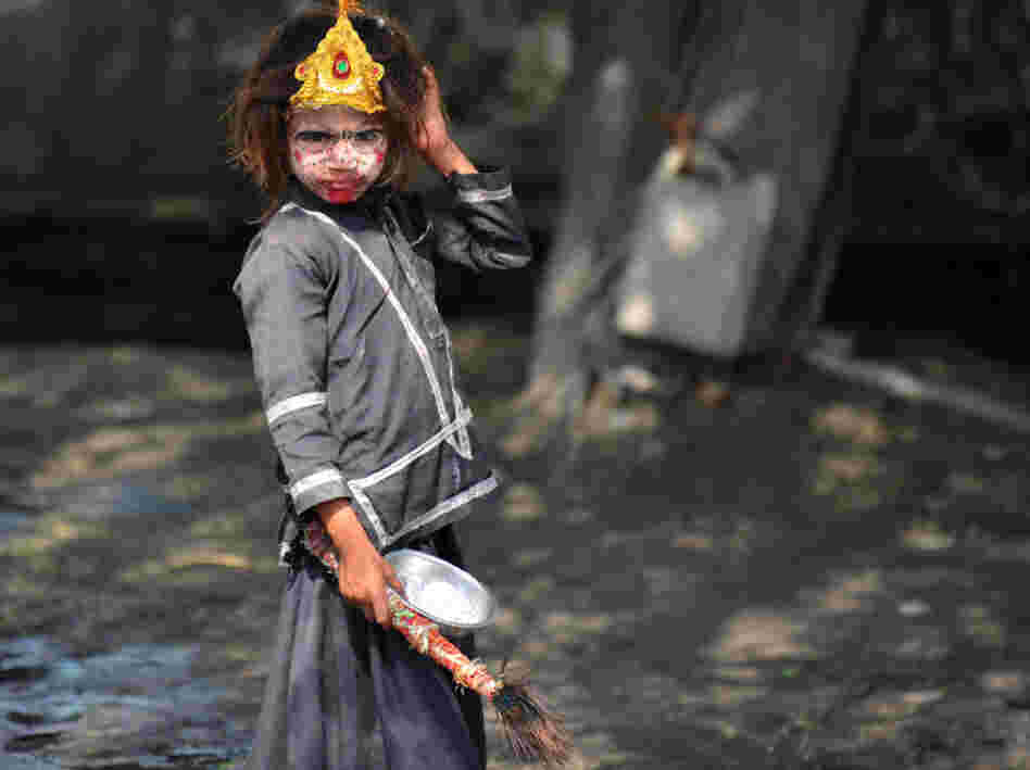An Indian girl with her face painted begs on the outskirts of New Delhi. Despite India's rapid economic growth, poverty and begging are still common.