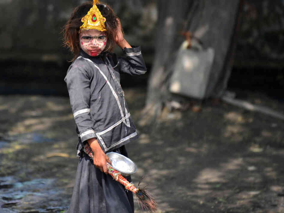 An Indian girl with her face painted begs on the outskirts of New Delhi. Despite India's rapid economic growth, poverty and begging are still common.