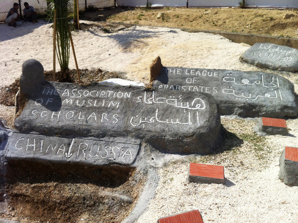 At the Altinozu camp in southeastern Turkey, the Syrian residents have built a mock graveyard. A freshly dug "grave" is for China and Russia, which vetoed a recent U.N. resolution against Syria. Other headstones are for the Arab League and the Association of Muslim Scholars, which have also disappointed the Syrian opposition.