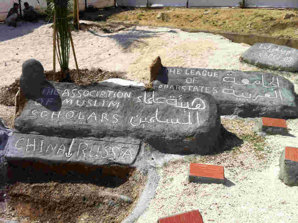 At the Altinozu camp in southeastern Turkey, the Syrian residents have built a mock graveyard. A freshly dug "grave" is for China and Russia, which vetoed a recent U.N. resolution against Syria. Other headstones are for the Arab League and the Association of Muslim Scholars, which have also disappointed the Syrian opposition.