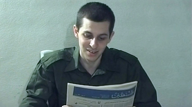 In this file image taken from a video released by Hamas in 2009, Israeli soldier Gilad Schalit is seen holding a newspaper in an unknown location. 