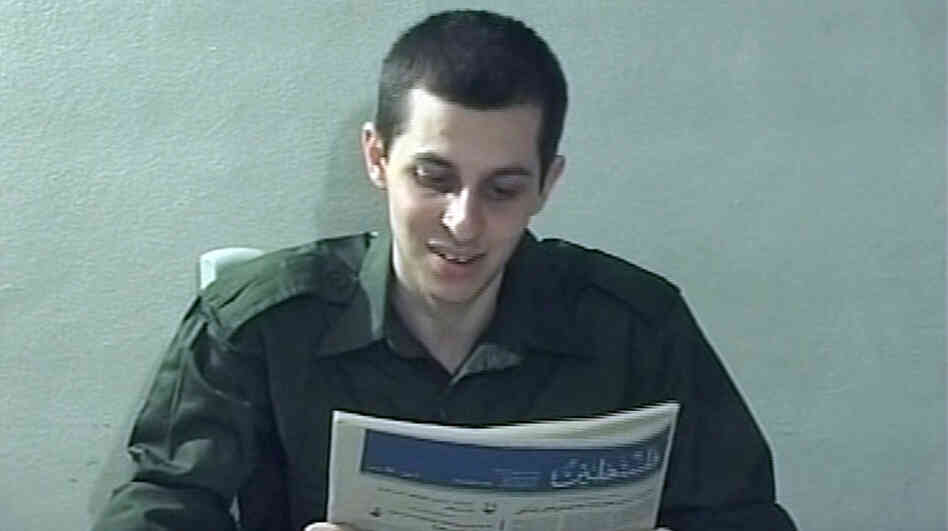 In this file image taken from a video released by Hamas in 2009, Israeli soldier Gilad Schalit is seen holding a newspaper in an unknown location. 