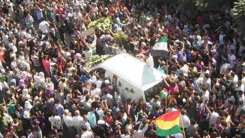 Mourners surround the hearse carrying the coffin of Kurdish opposition leader Meshaal al-Tammo during his funeral last Sunday in Amuda, in northern Syria. Supporters blamed the Syrian government for his death. 