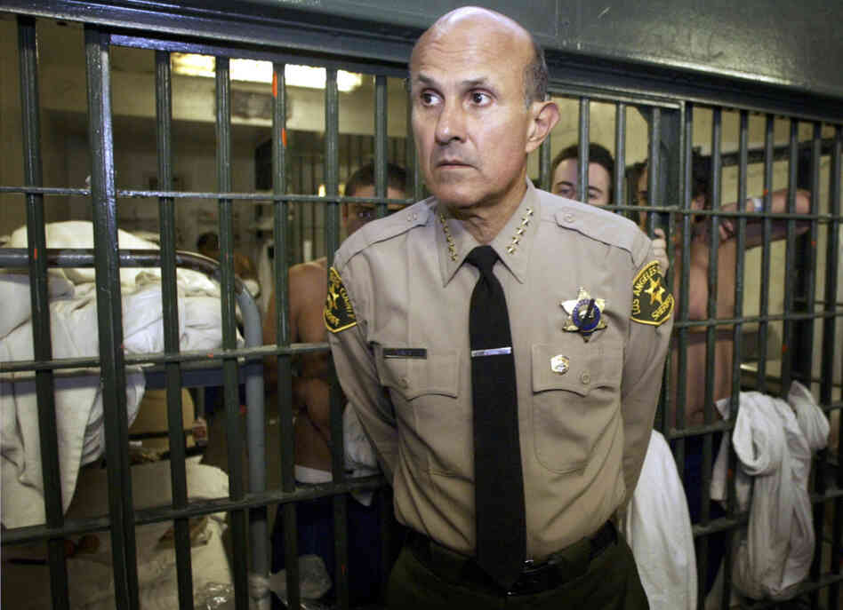 Los Angeles County Sheriff Lee Baca leads a tour inside the men's central jail at the Twin Towers Correctional Facility in Los Angeles in 2004. Baca is accused of ignoring inmate abuse by his deputies. Los Angeles County Sheriff Lee Baca leads a tour inside the men's central jail at the Twin Towers Correctional Facility in Los Angeles in 2004. Baca is accused of ignoring inmate abuse by his deputies.
