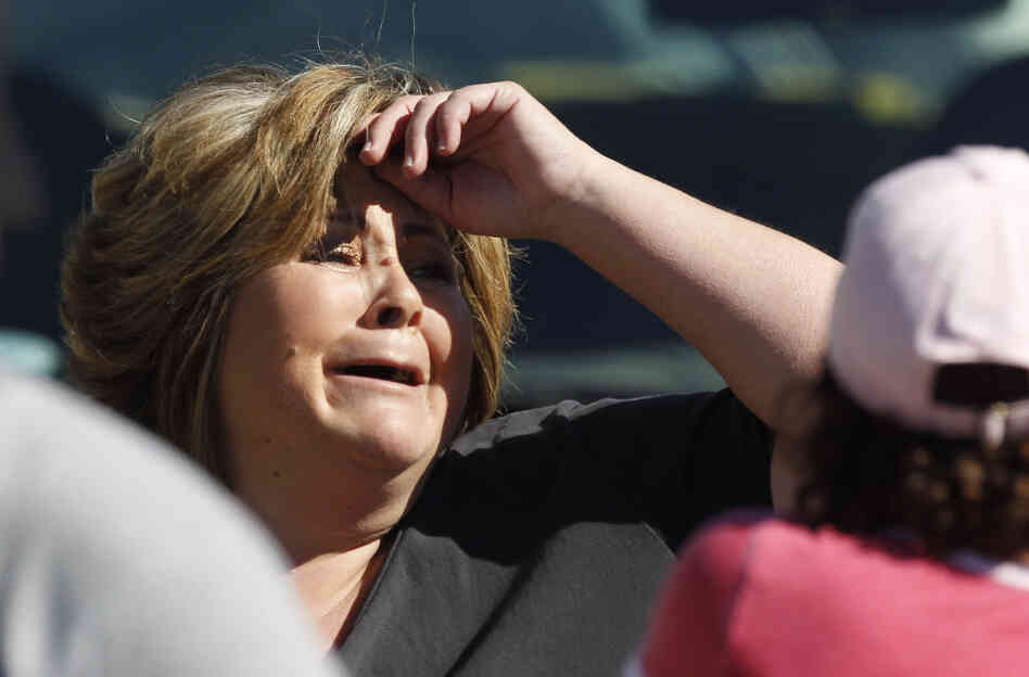An onlooker reacts near the site where six people were killed and three were wounded in a shooting at a hair salon in Seal Beach, Calif. An onlooker reacts near the site where six people were killed and three were wounded in a shooting at a hair salon in Seal Beach, Calif.