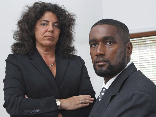 Albert Florence (right) sits at his home in Bordentown, N.J., on Tuesday with his attorney Susan Chana Lask. He challenged his strip search after a wrongful arrest on minor charges. 